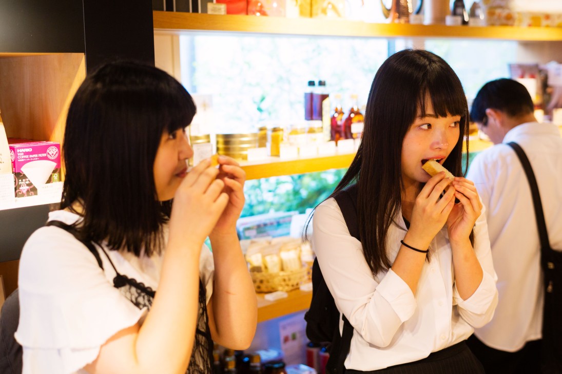 Two women sampling bread at 365 Nichi bakery in Tokyo, Japan.