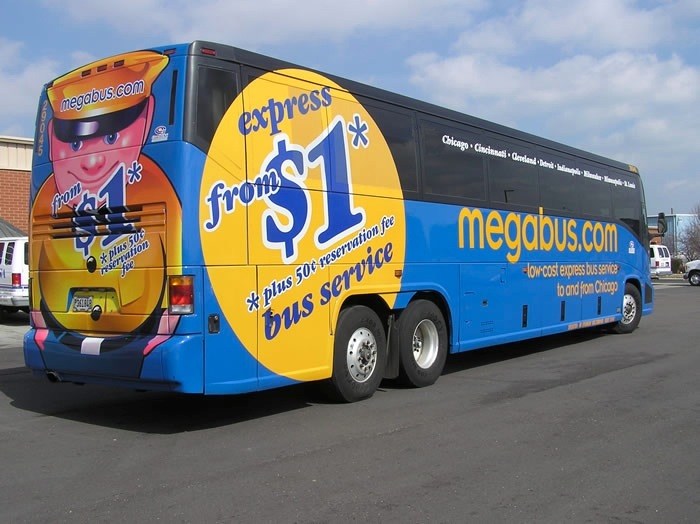 A blue and yellow megabus with cartoon character branding and express service advertising on its side.