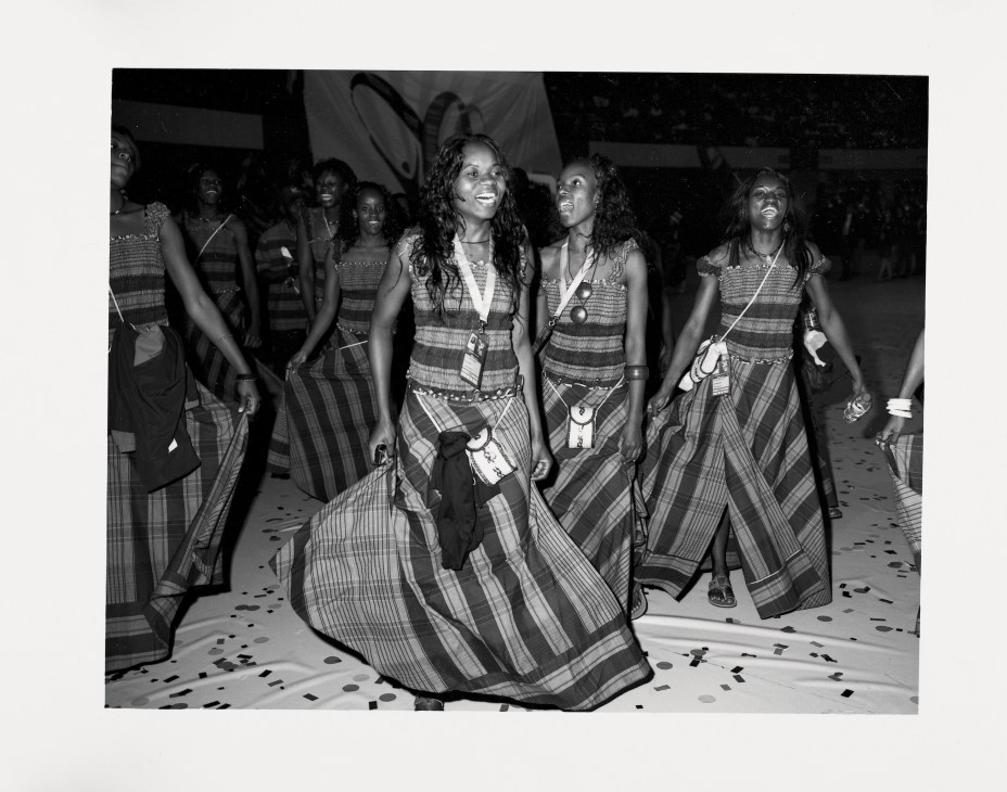 Mozambique team members in matching striped tunics dancing at the opening ceremony of the Jogos da Lusofonia.