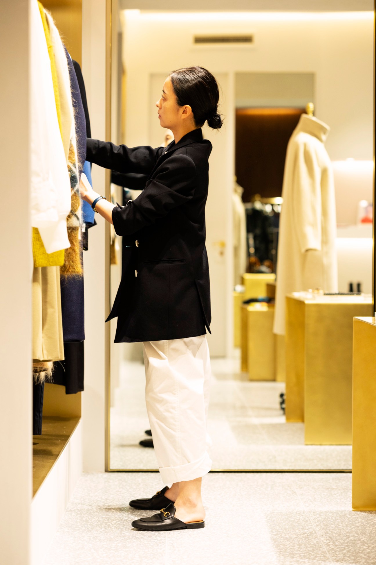 Loeff designer Rika Suzuki examining fabric swatches in a minimalist showroom