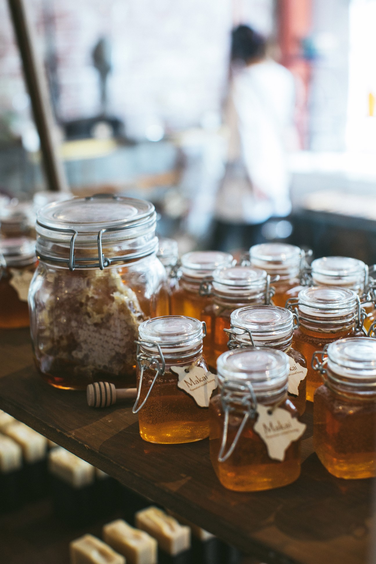 Jars of Mauka and Makai honey from the Big Island displayed on a dark table with labels.