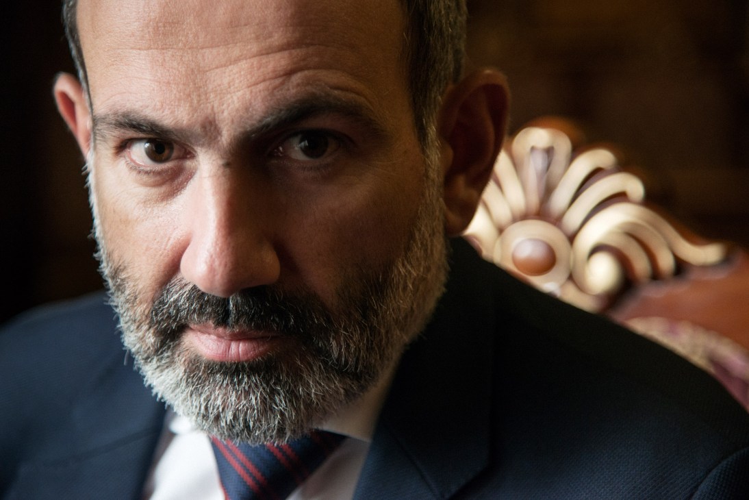 Prime Minister Nikol Pashinyan in a close-up portrait looking directly at the camera.