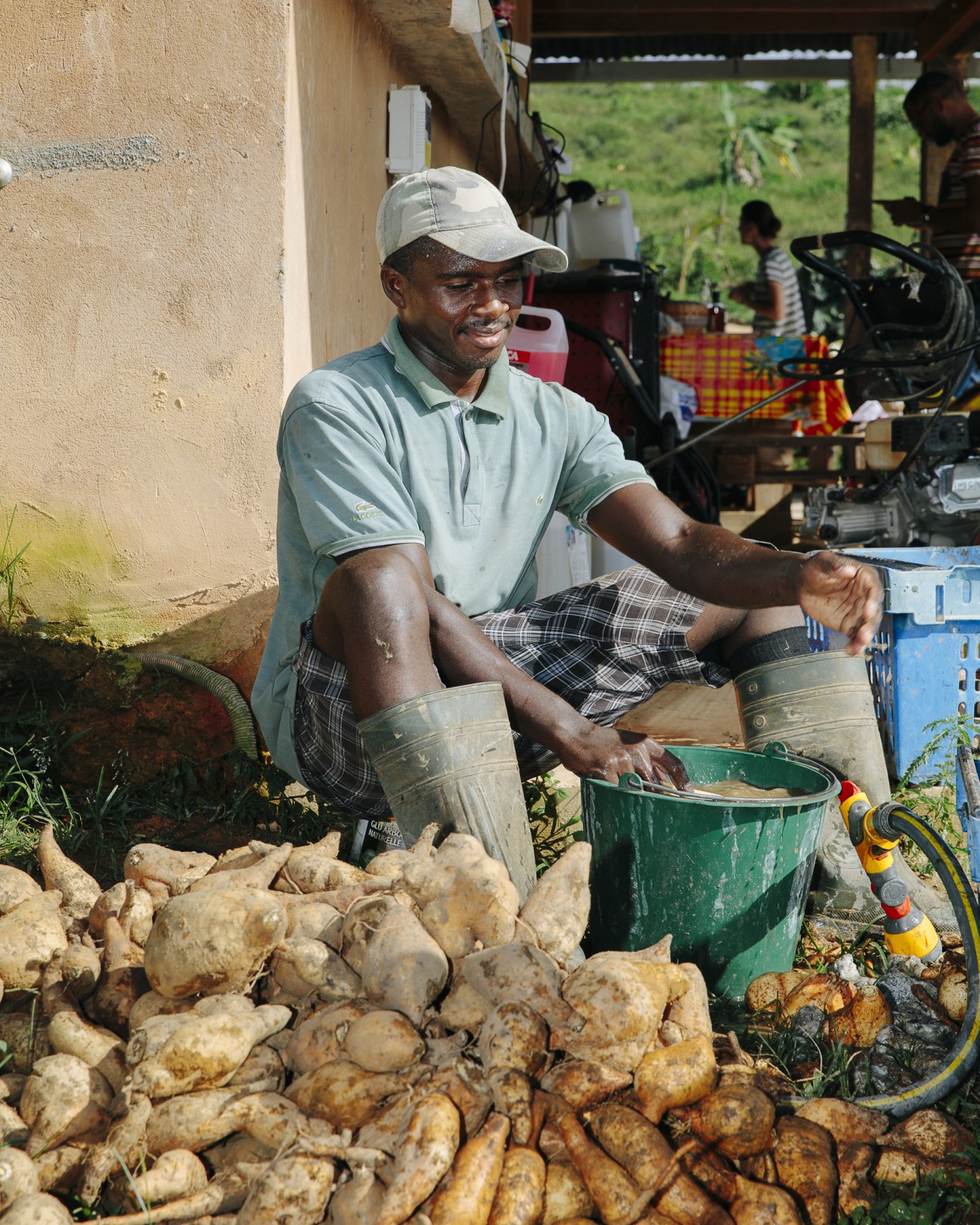 Man cleaning sweet potatoes at Jean-Hubert François' farm in French Guiana