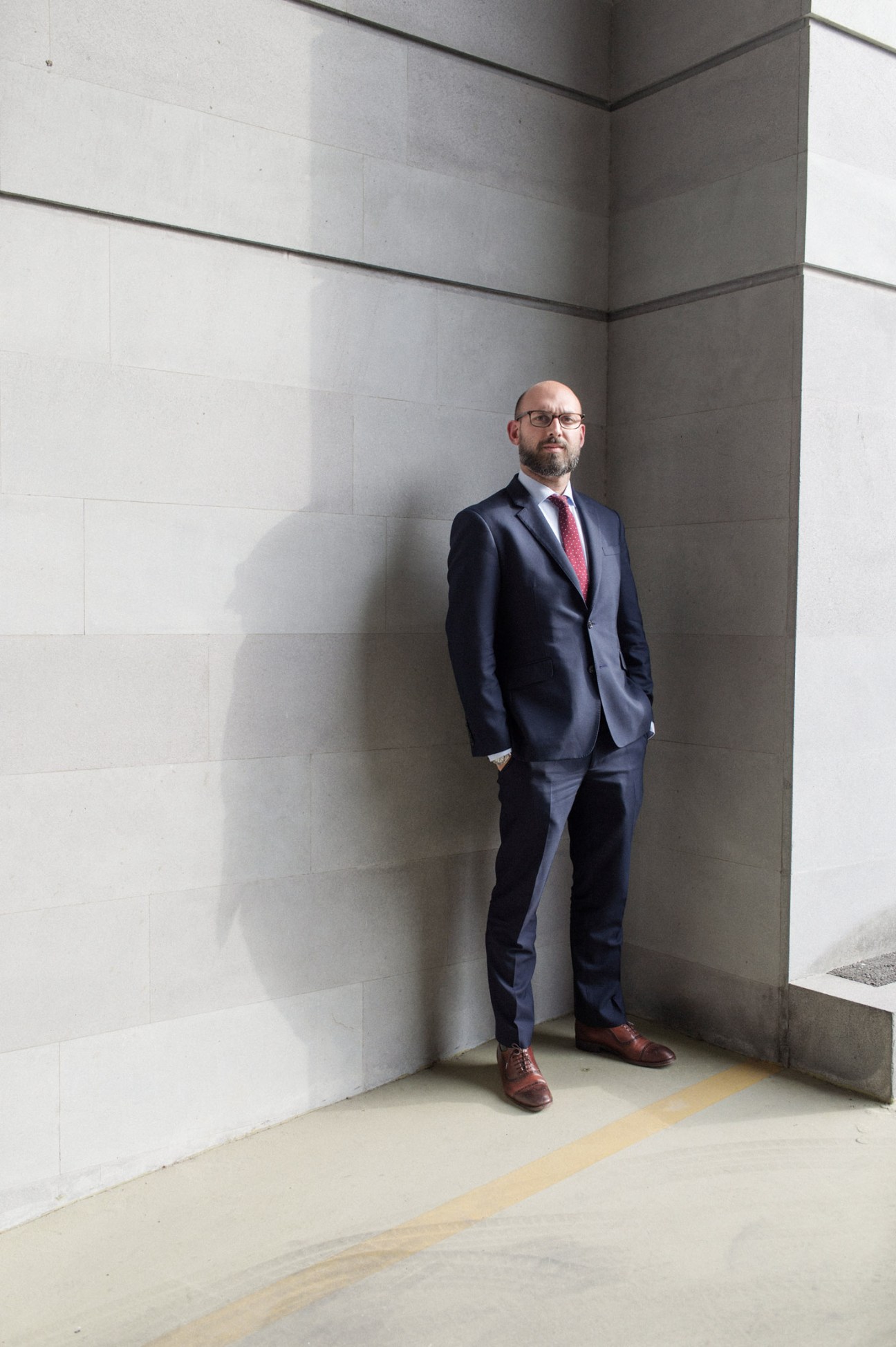 Babken Ter-Grigoryan, deputy minister of diaspora, standing in a formal portrait against a concrete wall