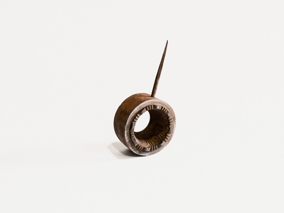 Antique wooden tool with a hollow cylindrical body and pointed metal rod attached to the top.