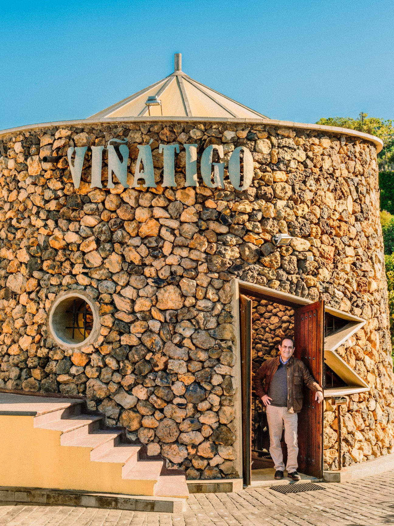 Juan Jesús Méndez stands in the doorway of Viñátigo's distinctive stone dome-shaped winery in Tenerife.