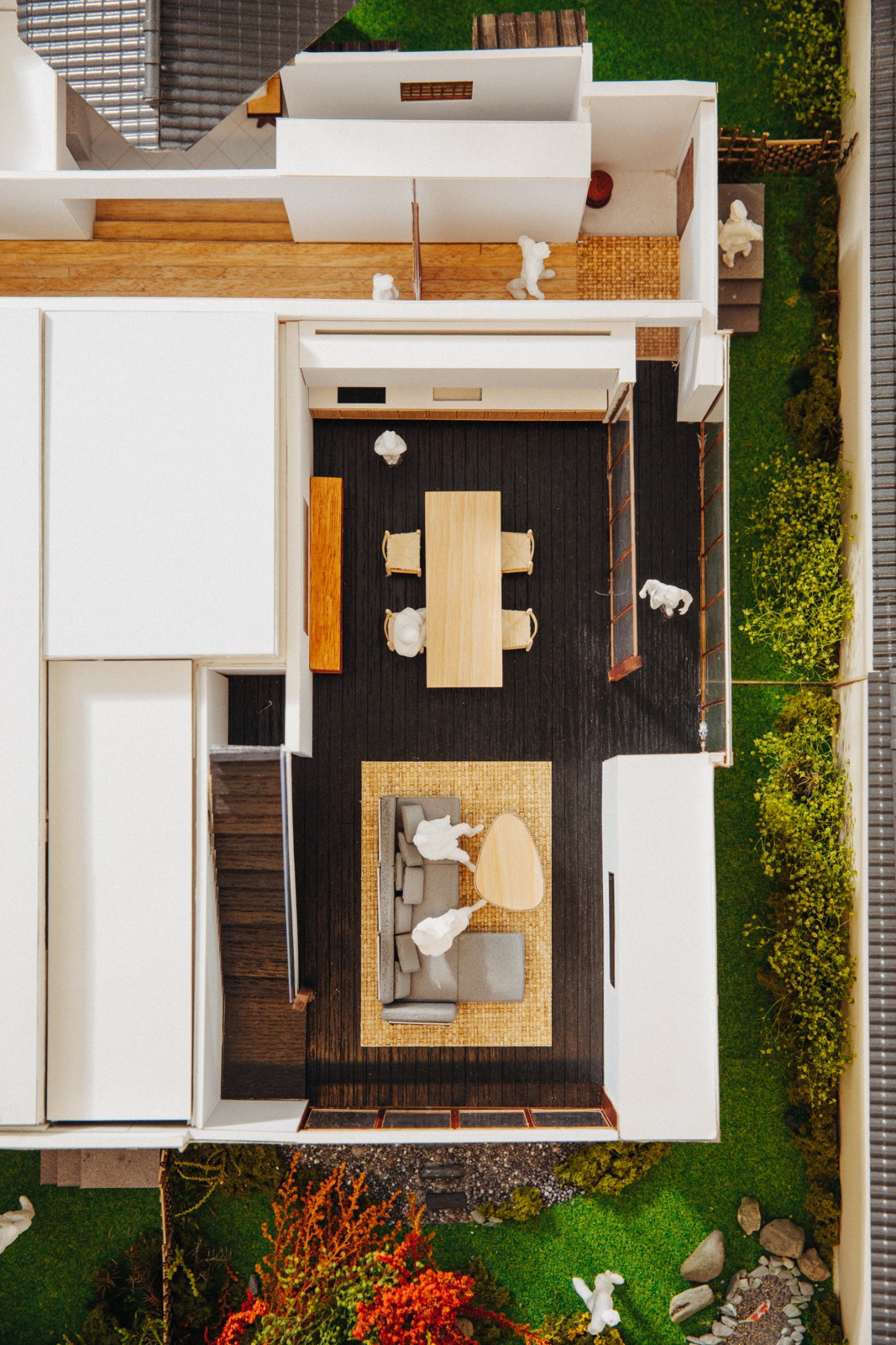 Aerial view of detailed architectural model showing hotel interior with dining area, seating, and miniature landscaping