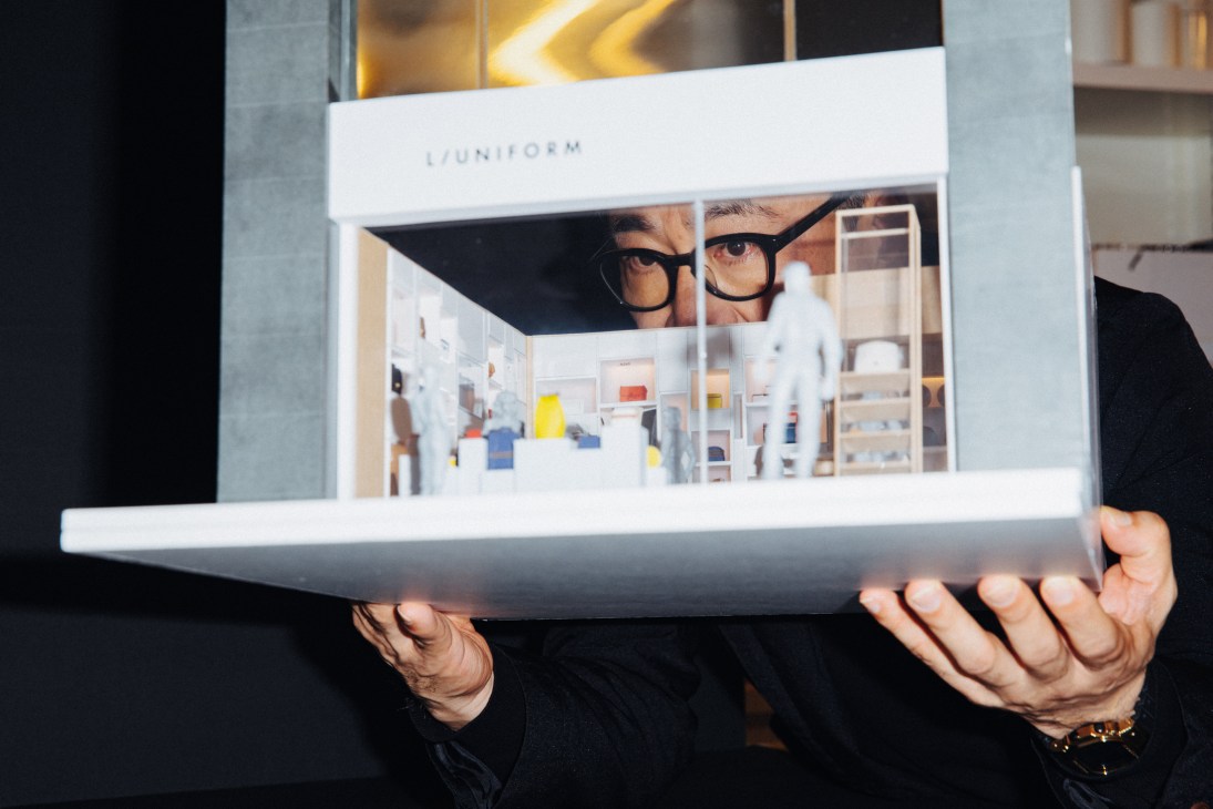 Masamichi Katayama examining a detailed architectural scale model
