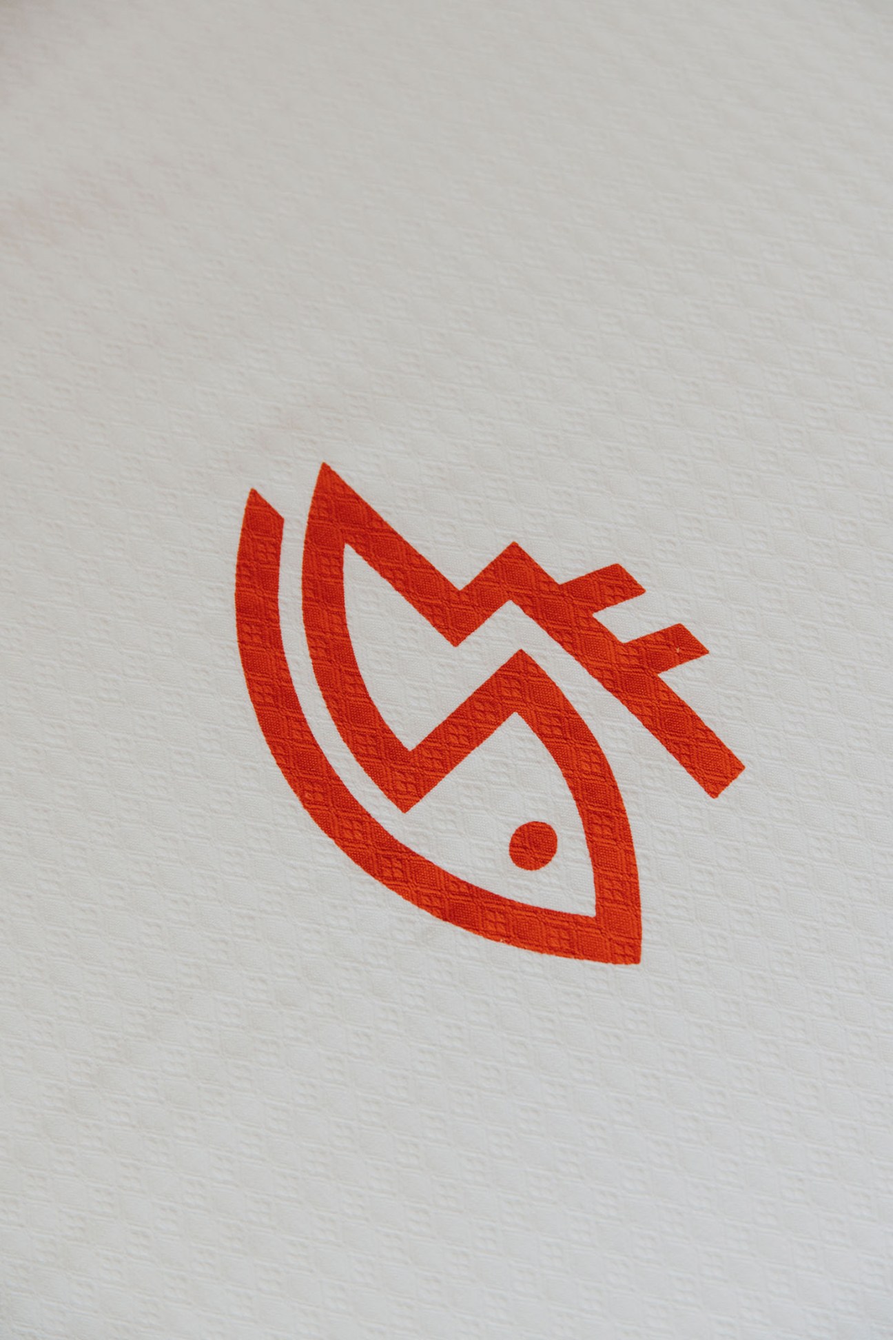 Red Instituto Social de la Marina logo featuring an eye symbol with lightning bolt on white paper.