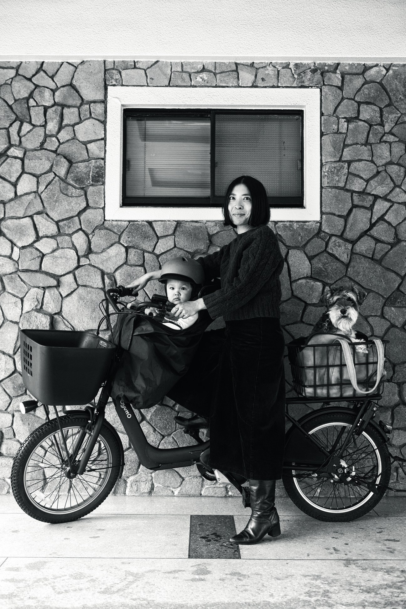 Portrait of a mother with child and dog on a mama-chari electric bicycle in Tokyo