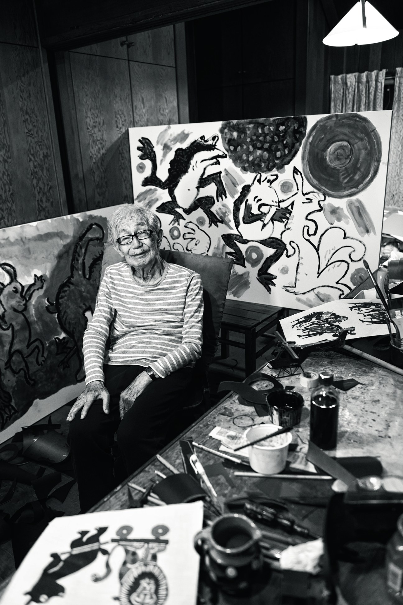 Portrait of Samiro Yunoki, a 97-year-old textile designer in his studio surrounded by colorful artwork and painting supplies
