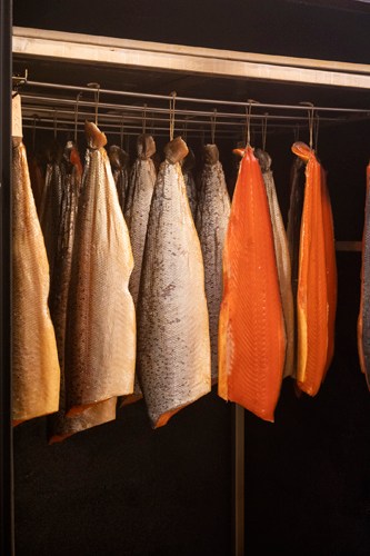 Kitchen towels and aprons hanging on a rack in a restaurant kitchen