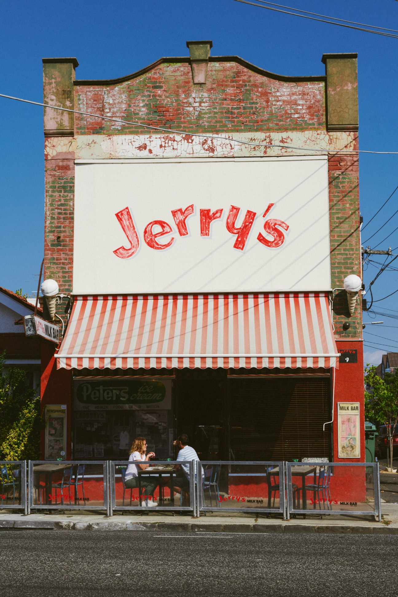 Jerry's Milk Bar storefront in Elwood with red-and-white striped awning and distinctive signage.