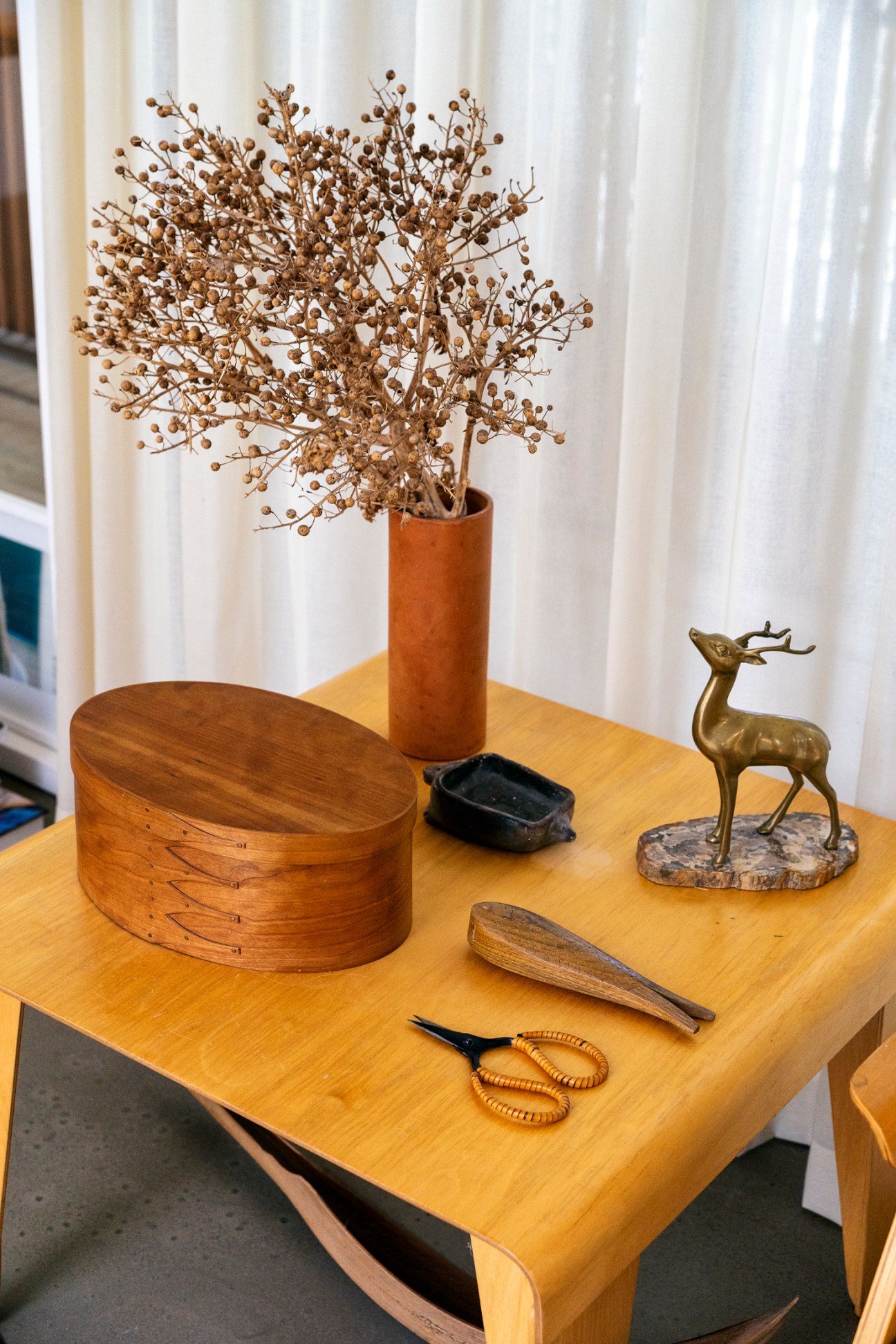 Display of international handicrafts and decorative objects on wooden shelving