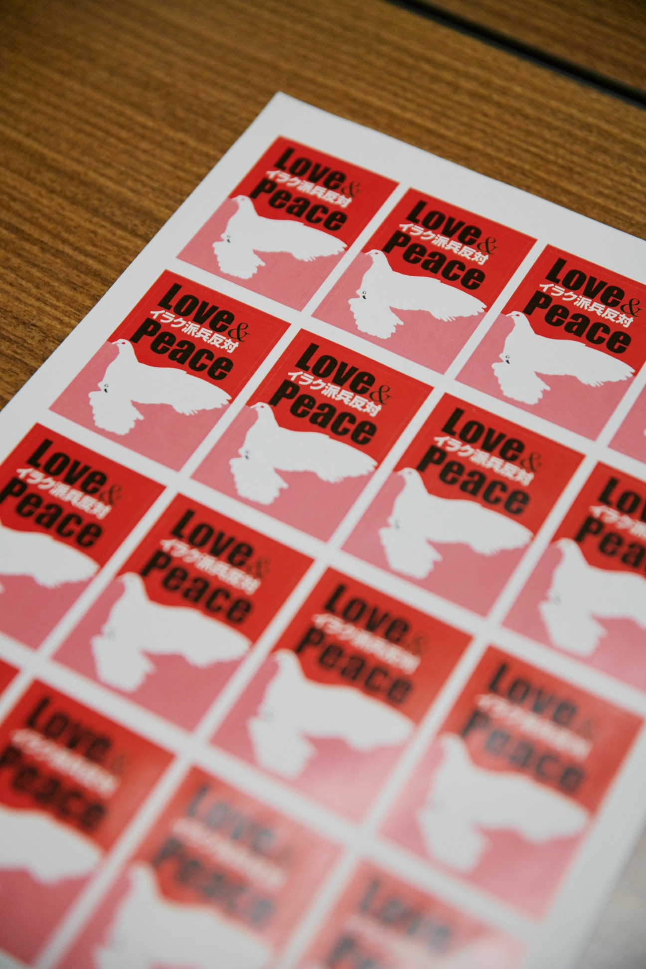 Sheet of red and pink stickers with white dove symbols and "Love & Peace" text in English and Japanese