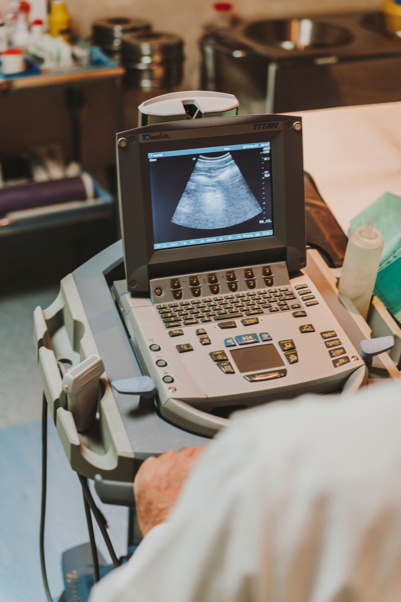 A portable ultrasound machine displaying a medical scan on its screen aboard the hospital ship.