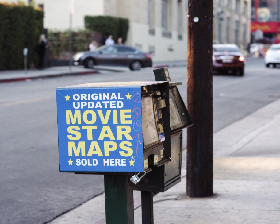 Movie star maps vending machine on Hollywood Boulevard street corner.