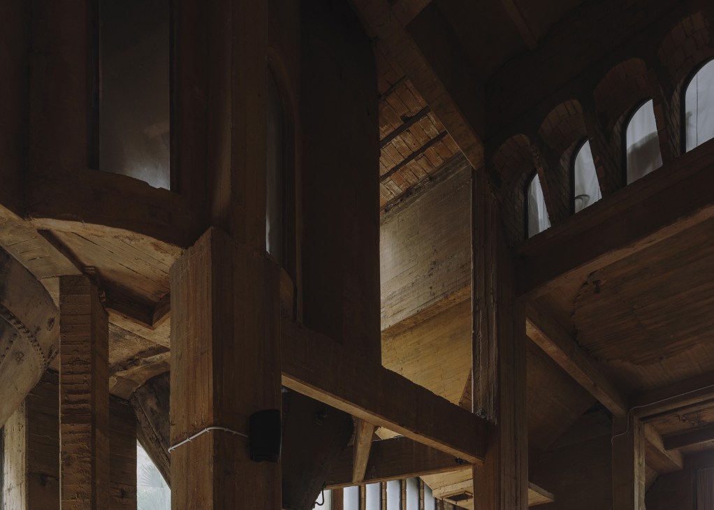 Interior view of the Cathedral showing industrial concrete architecture with high ceilings and wooden beams.