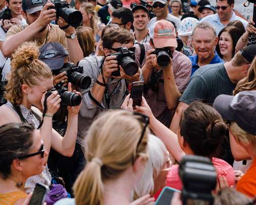 Crowd of journalists and camera operators gathered around a political event at Iowa State Fair