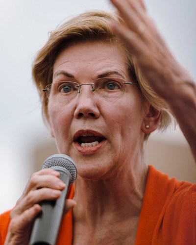 Elizabeth Warren speaking at a microphone on the Soapbox stage at Iowa State Fair