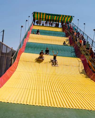 People riding down the Giant Slide on burlap sacks at Iowa State Fair