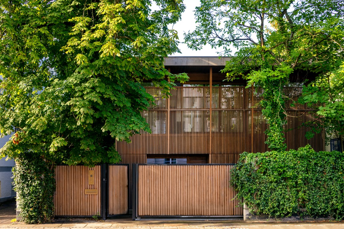 Front facade featuring Japanese koshi wooden louvre screens creating privacy while maintaining aesthetic appeal