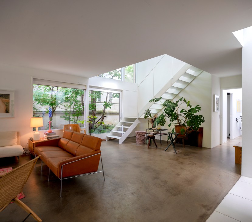 Spacious interior with white walls, wooden elements and skylights creating bright, airy atmosphere