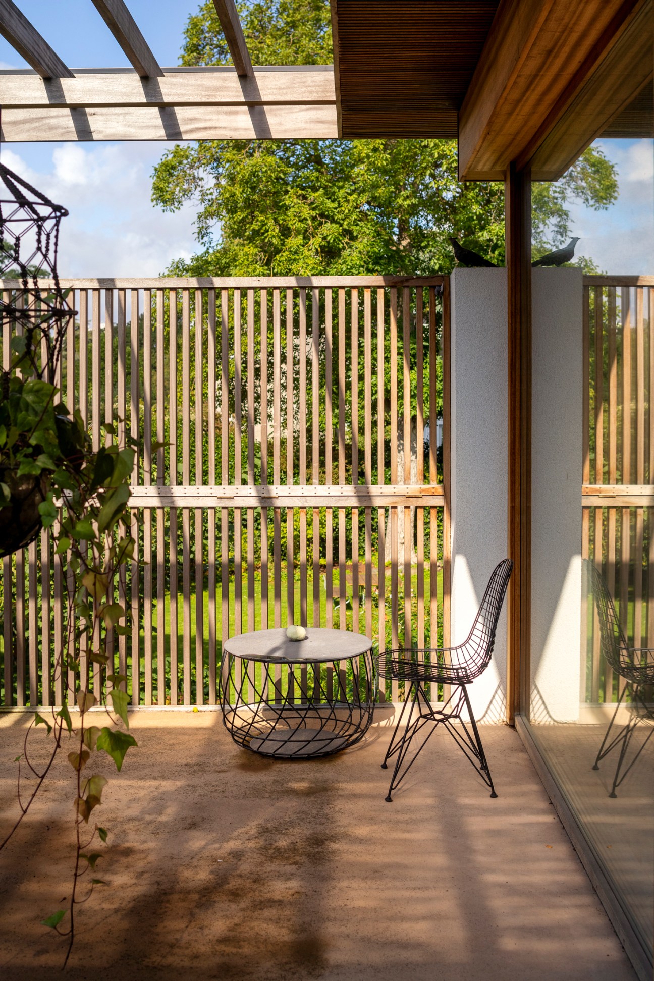 Sunny terrace area adjacent to master bedroom with wooden decking and garden views