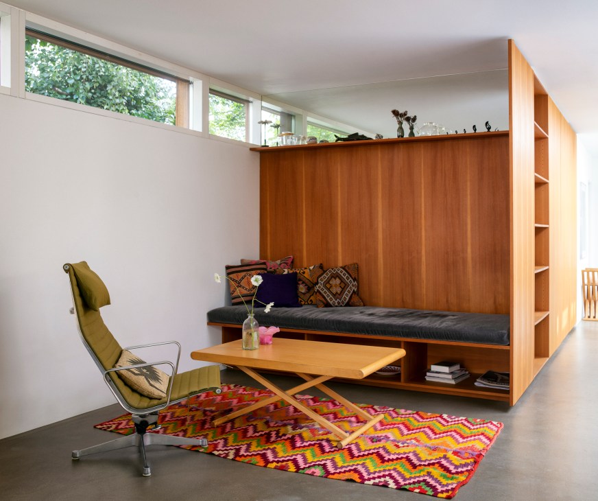 Cosy corner seating area with cushions and natural lighting from skylights above