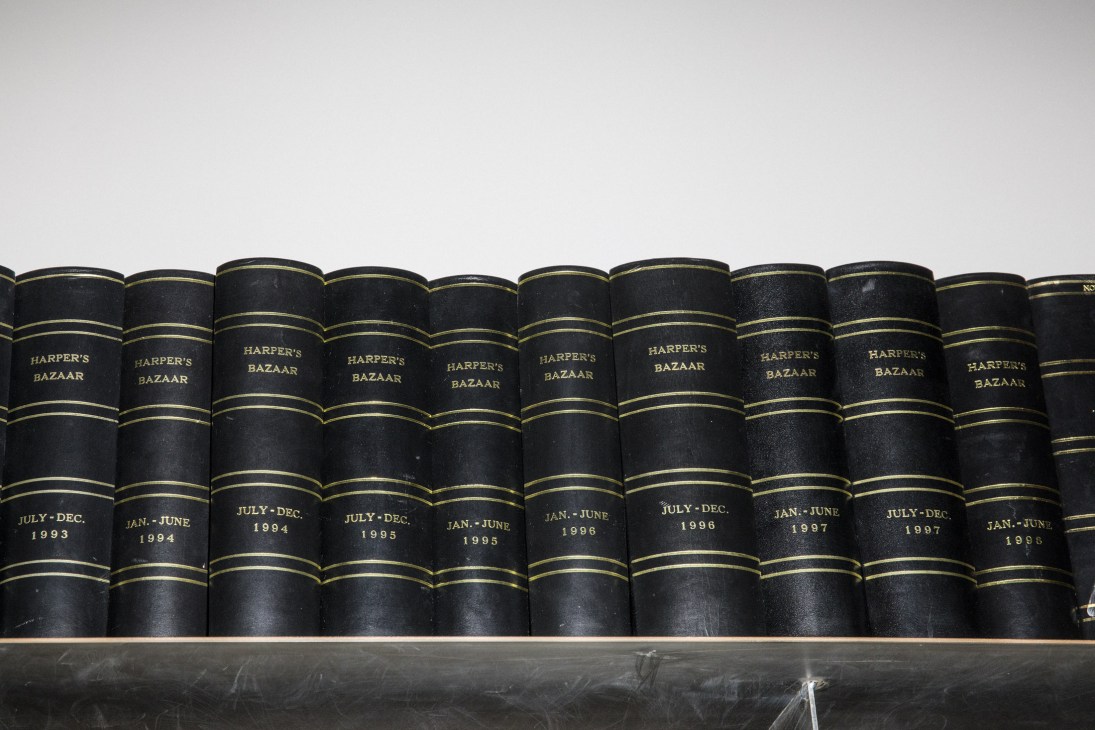 Bound volumes of Harper's Bazaar magazines with black leather spines and gold lettering, arranged on a shelf showing publication dates from 1993 to 1998.