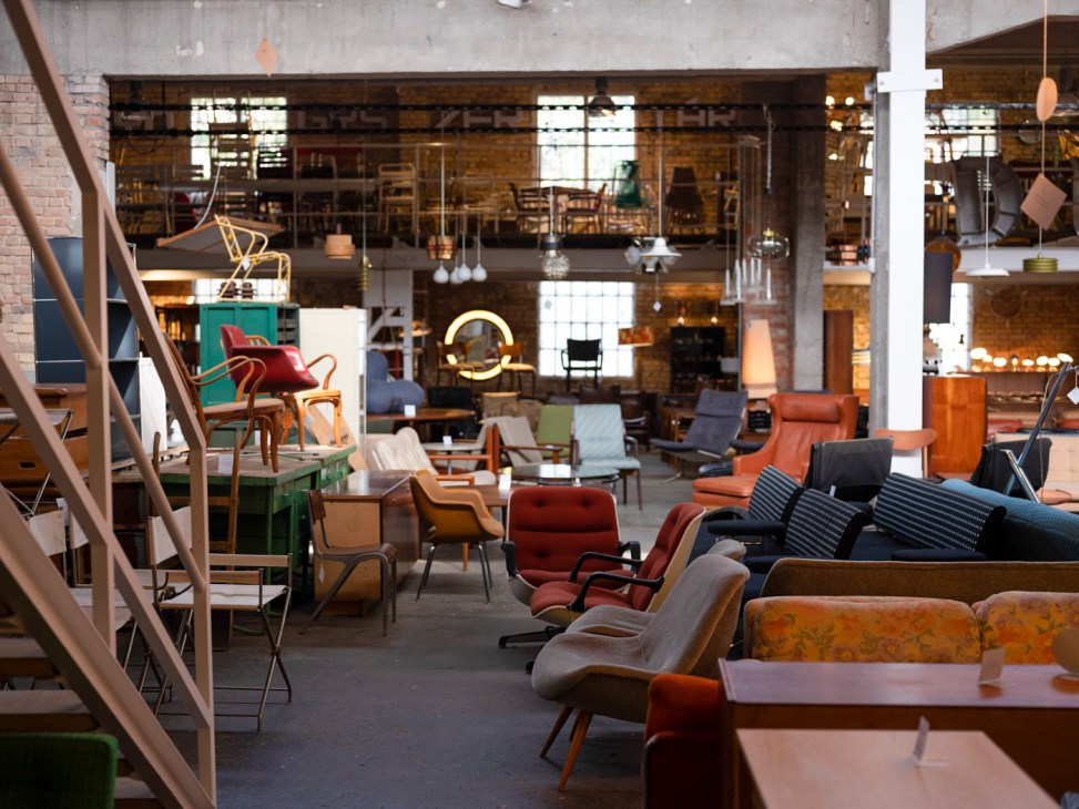 Interior of Möbelkunst furniture showroom displaying mid-century chairs, sofas, and design pieces.