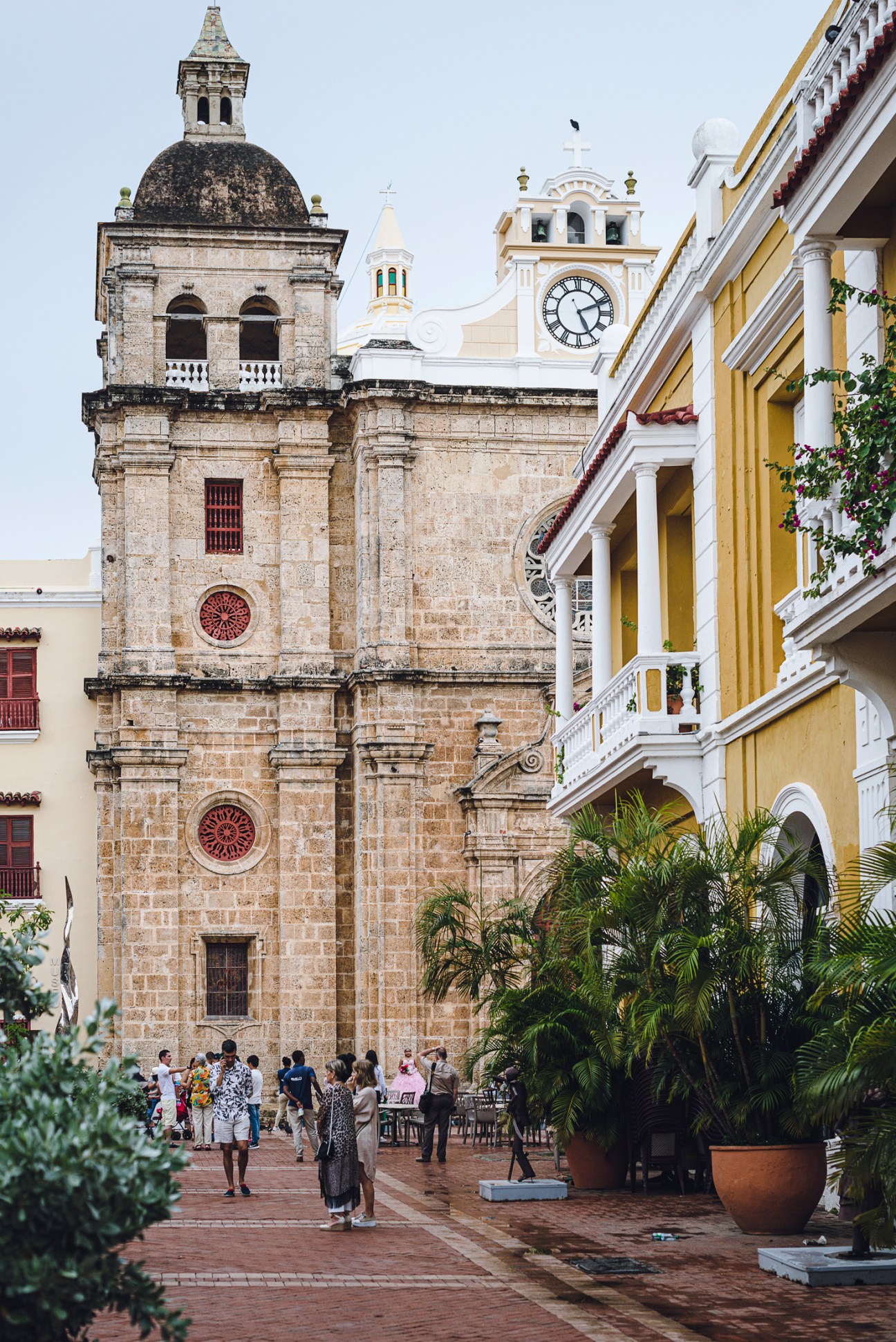 Historic stone cathedral with clock tower and colonial buildings in Cartagena's old walled city