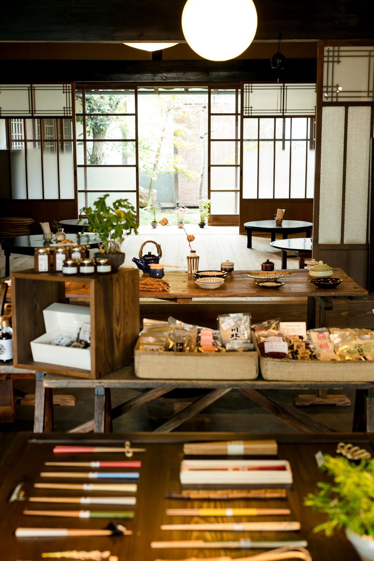 Interior of Breath & Roy craft shop and café in Sasayama showing traditional Japanese design with wooden counters, paper screens, and local products.