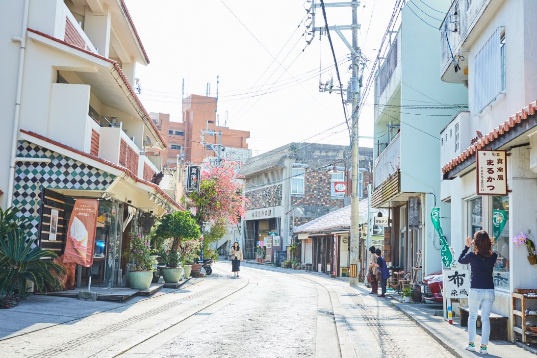 Quiet street lined with pottery shops and traditional buildings in Naha's Yachimun pottery district