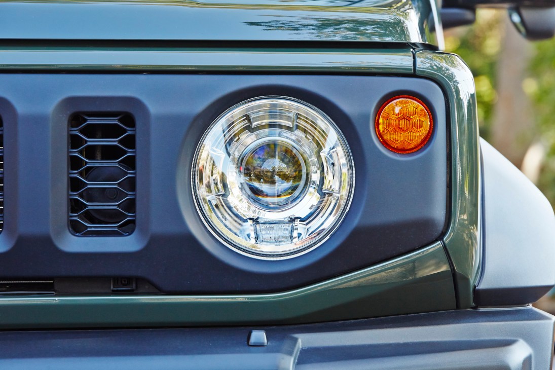 Close-up view of Suzuki Jimny's distinctive circular headlight design feature