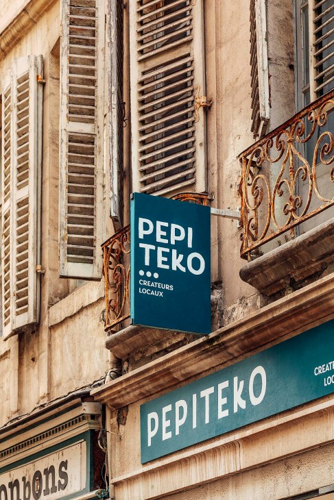 Pepiteko storefront with teal signage displaying the shop name and 'Createurs Locaux' on a weathered building facade