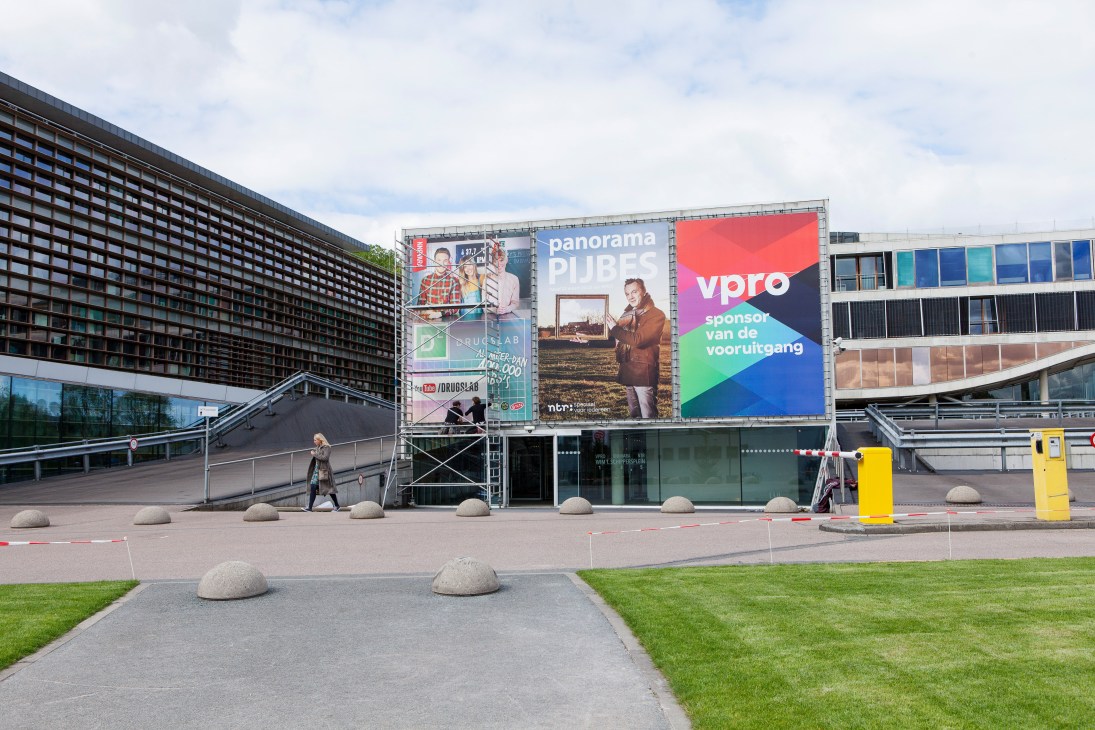 VPRO's headquarters Villa VPRO in Hilversum with large promotional billboards and modern architecture.