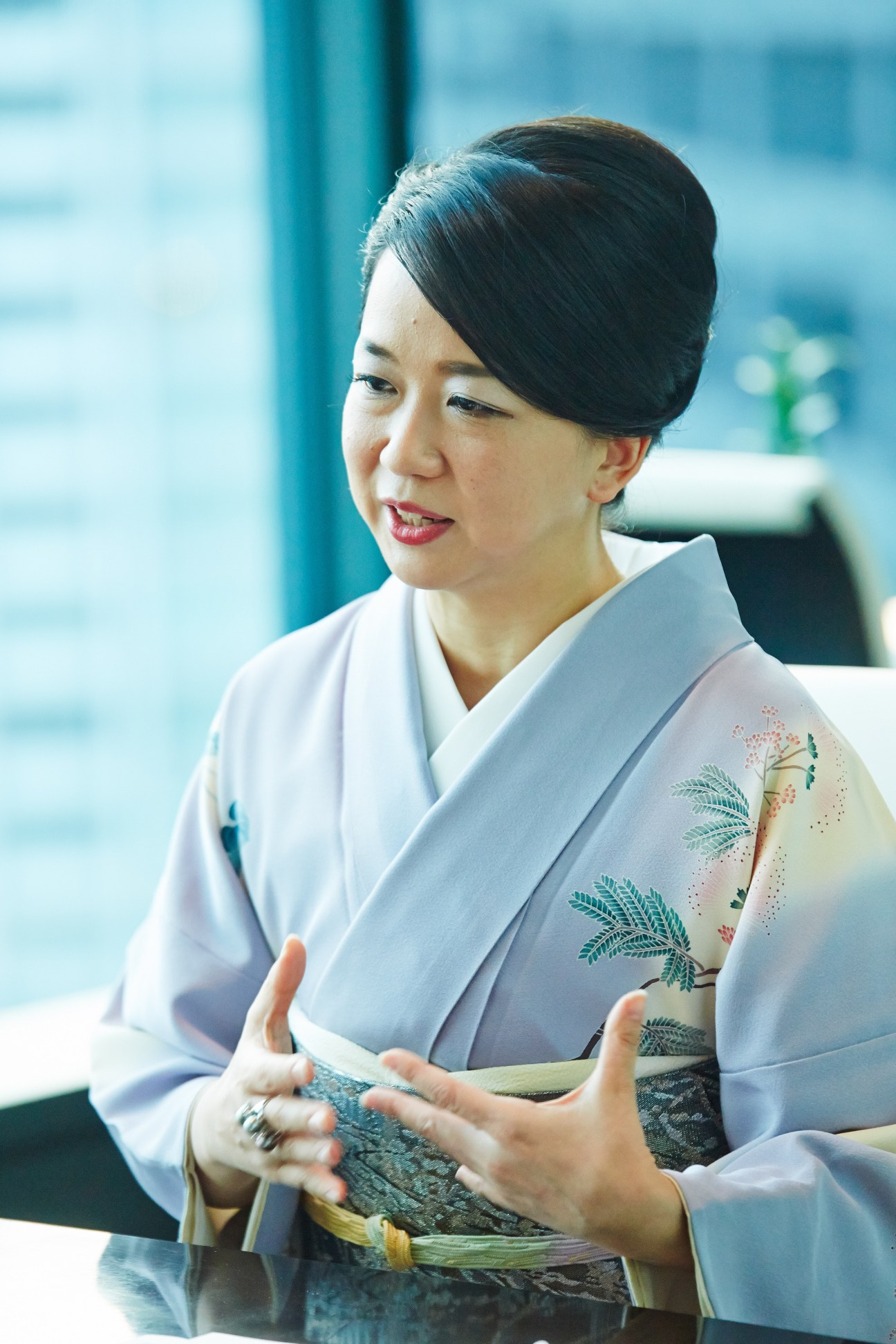 Miwako Date, CEO of Mori Trust, wearing a light blue kimono while discussing business strategy.
