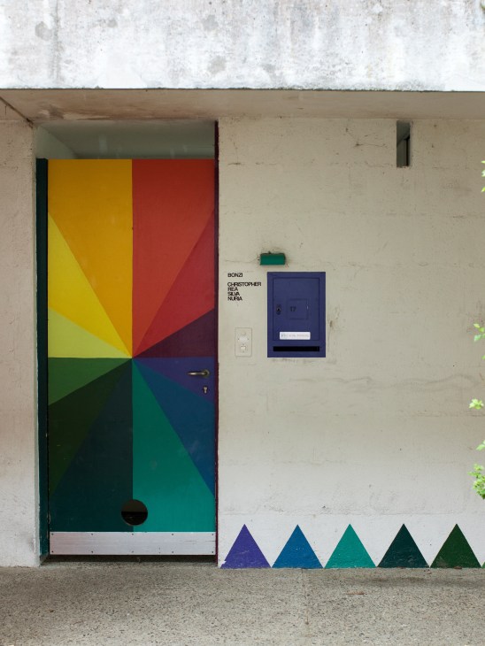 Colorful front doors showing residents' personal decorating choices