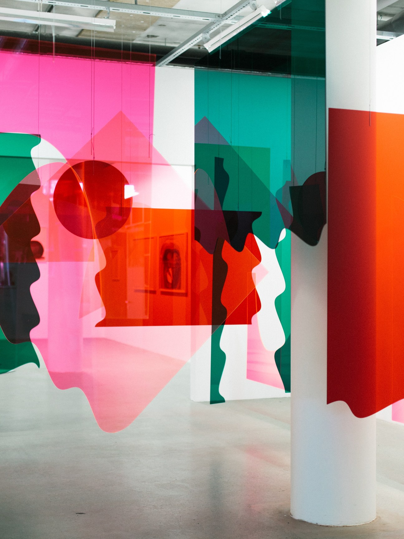 Colorful translucent acrylic installation with geometric shapes in pink, green, red and orange at Kunsthall Oslo.