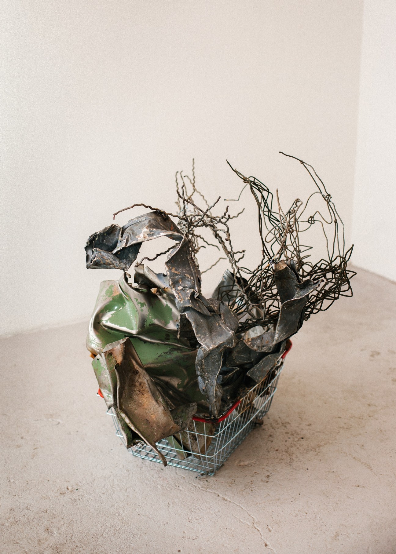 Franz West's untitled 2009 installation featuring metal and found objects in a shopping cart