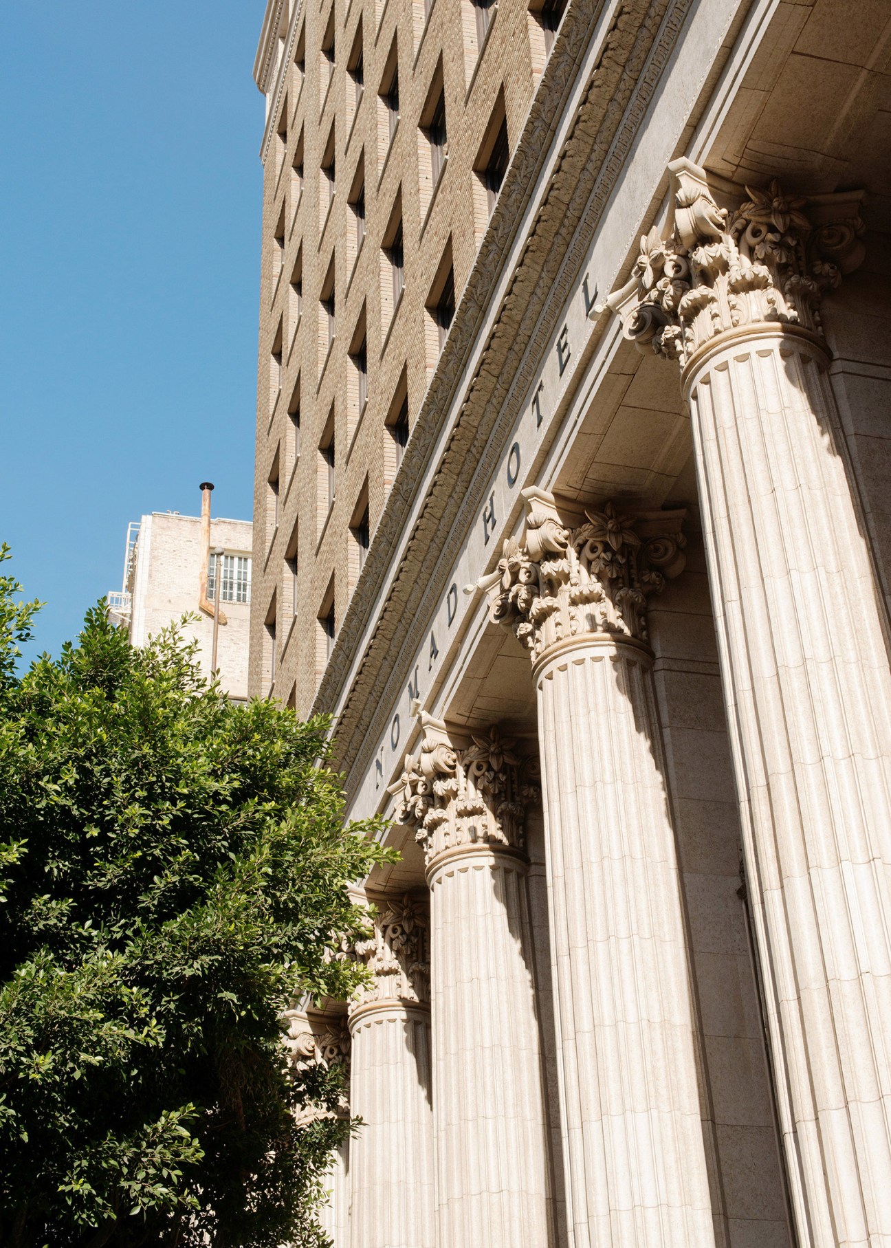 Ornate Corinthian columns with decorative capitals on the neoclassical Bank of Italy building in Los Angeles.