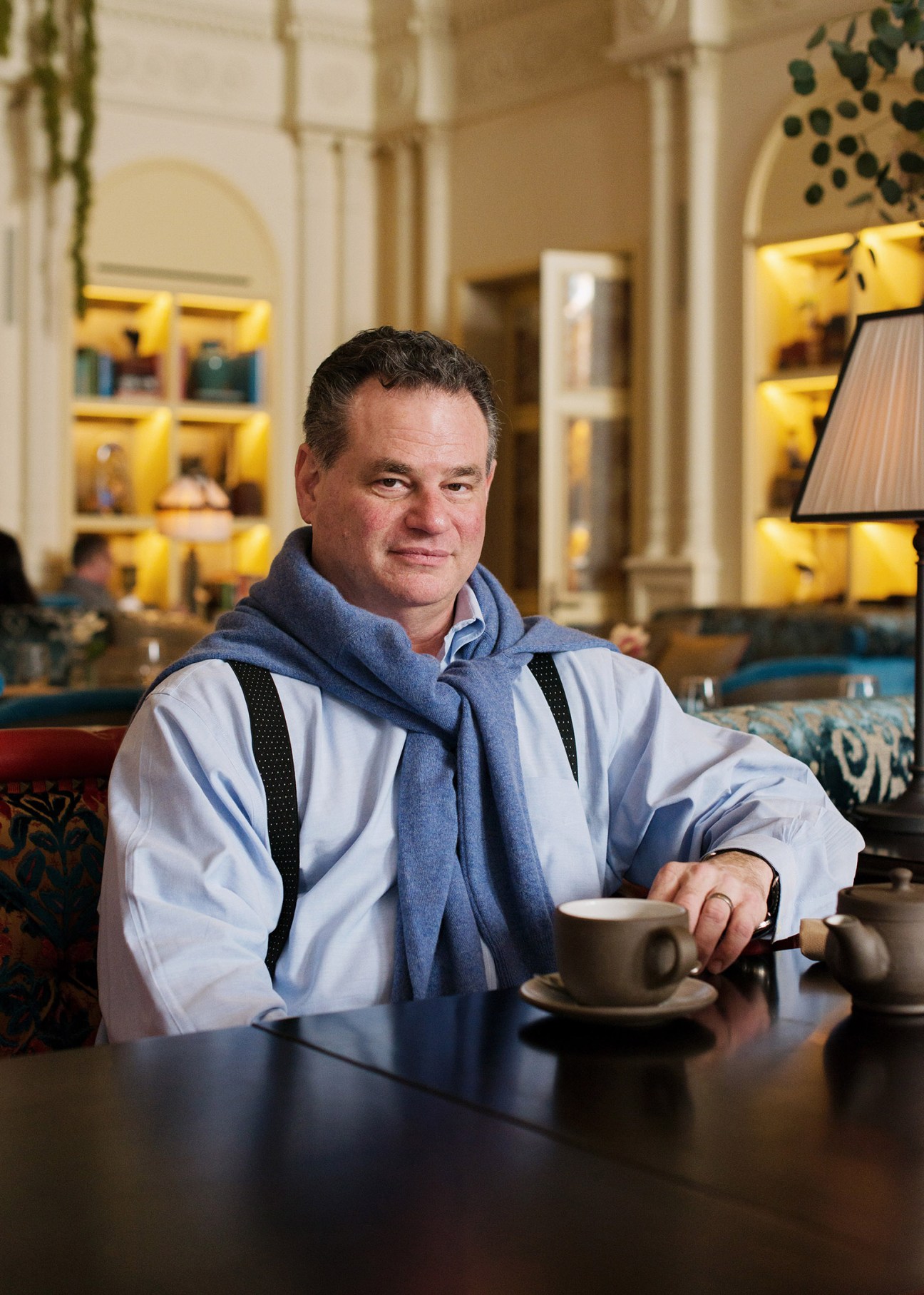Andrew Zobler, CEO of Sydell Group, sits in the NoMad Los Angeles lobby with a cup of coffee.