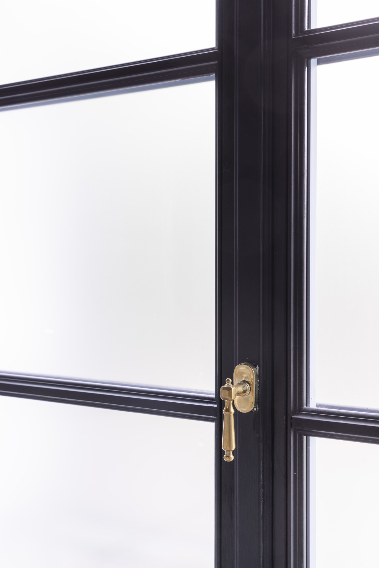 Black timber window frame with brass handle, designed as a replica of original windows at Six in Milan.