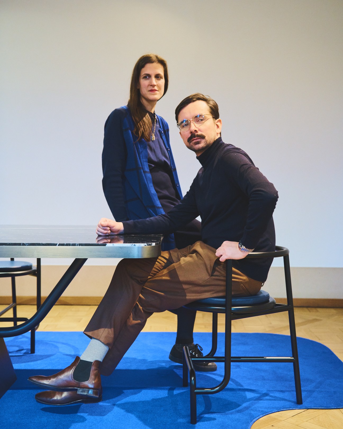 Léa Padovani and Sébastien Kieffer of Studio Pool seated at a table in a modern interior space