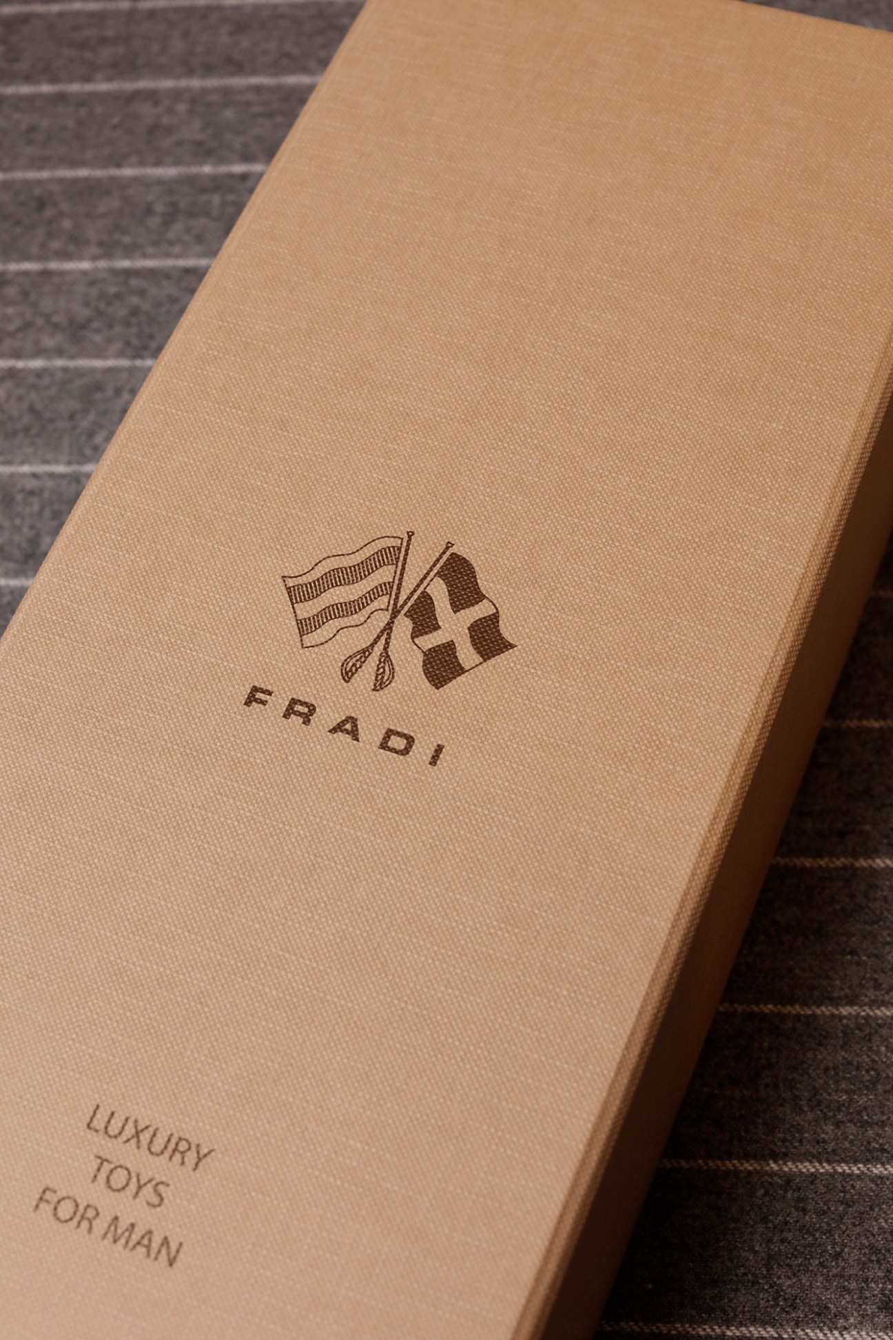 Fradi menswear brand packaging box with flags logo and text.