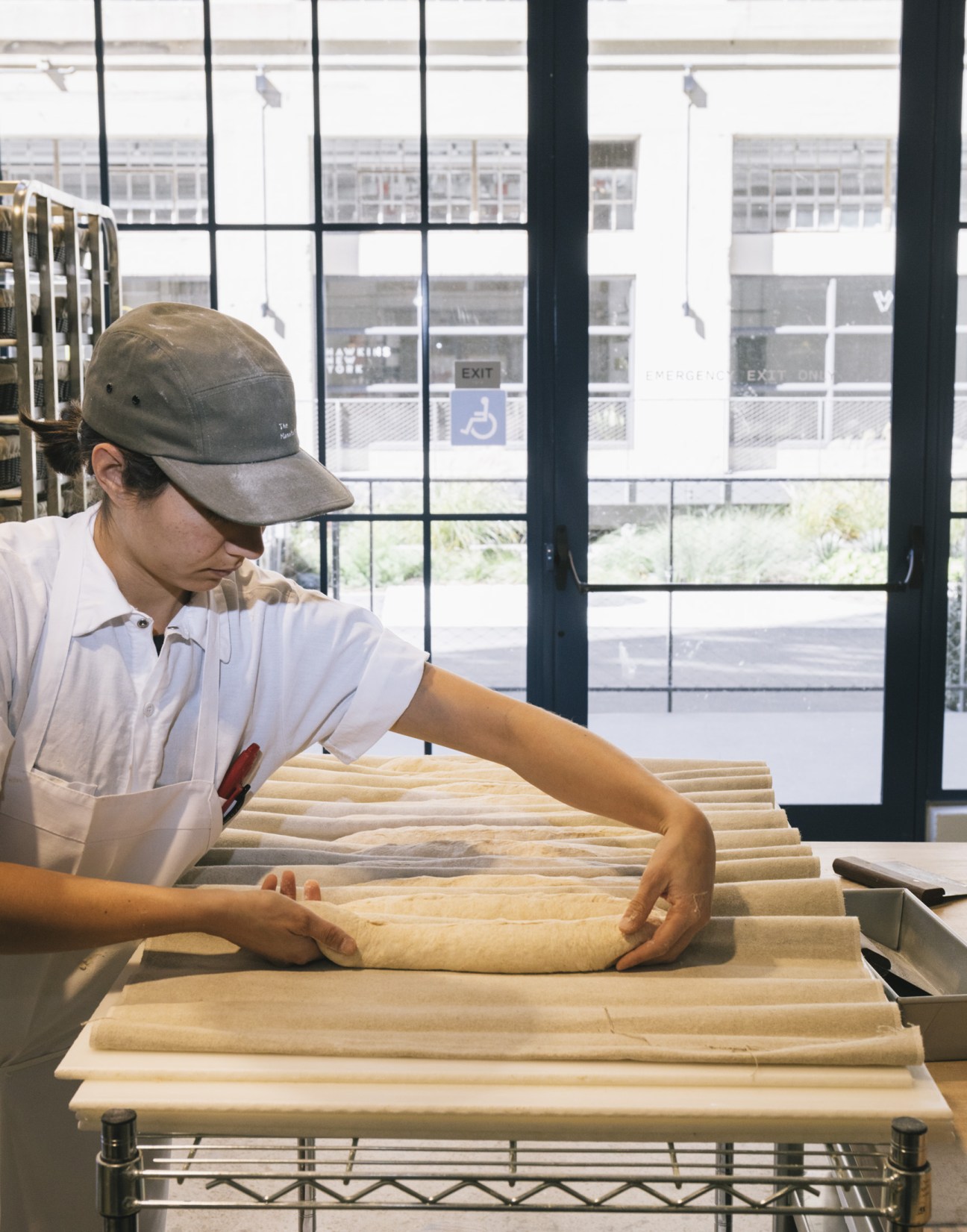 Baker shaping ciabatta dough by hand at The Manufactory in Los Angeles.