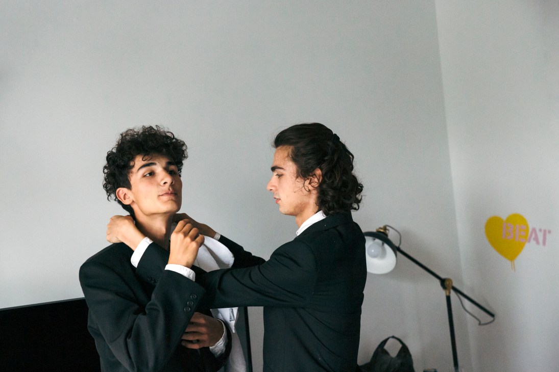 Turkish brothers Luka and Léo Ispir adjust each other's formal attire backstage at the Tsinandali Festival.