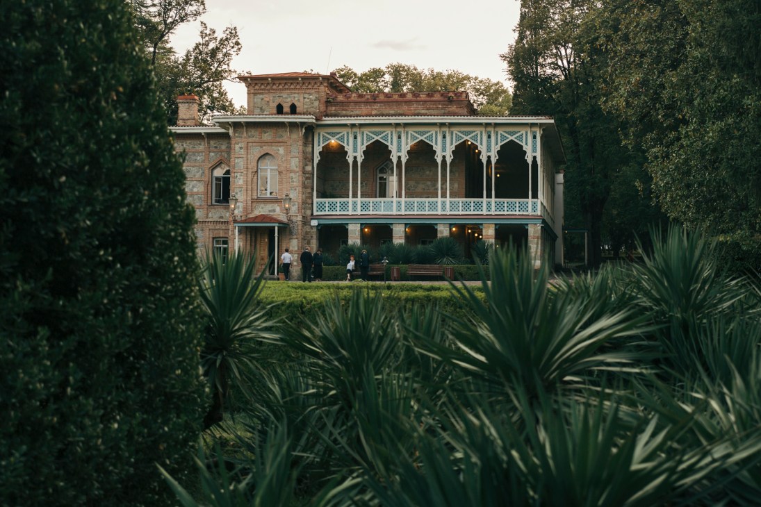 Prince Chavchavadze's restored 18th-century palace with ornate white portico, stone facade and manicured gardens at Tsinandali estate in Georgia.