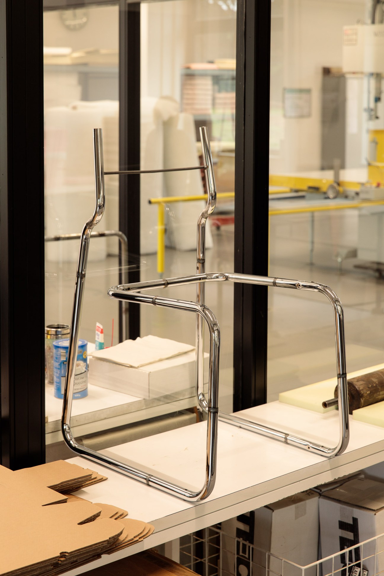 A tubular steel B25 chair frame under construction displayed on a workbench at Tecta factory.